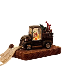 Vintage bronze Christmas truck water lantern featuring Santa Claus and light-up snow effect
