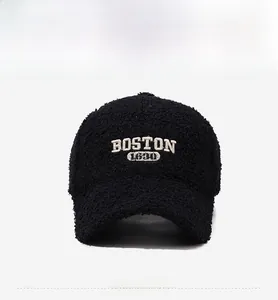Detailed view of black teddy fleece baseball cap with Boston 1630 white embroidery