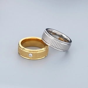 Polished titanium steel striped rings in gold and silver with a single white diamond inlay