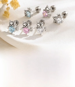 Detail of titanium steel cat ear studs with heart zircon stones and screw back base