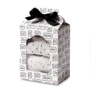 White gift box with cactus print, transparent window and black ribbon bow for packaging