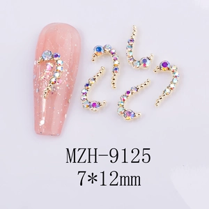 Macro shot of 7x12mm Aurora crystal heart nail charms with golden alloy base on nails