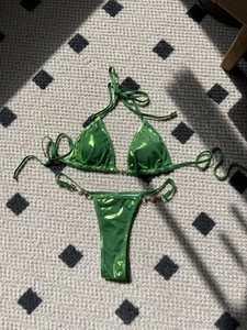 Detail of neon green metallic bikini set with elegant white pearl bead accents