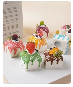 Macro shot of assorted colorful PU foam mini cakes with cream and fruit toppings