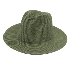 Detailed macro view of military green Panama straw hat with fine texture and Fedora crown