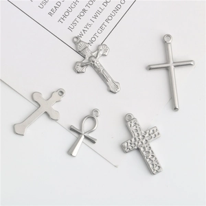 Set of five diverse stainless steel cross pendants with religious and modern designs