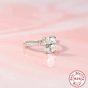 Close-up of an oval-cut diamond ring in 925 sterling silver with small side stones