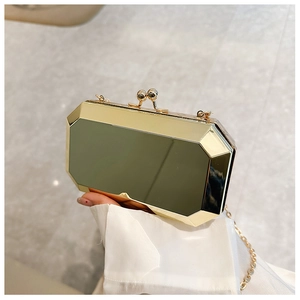 Close-up of a gold geometric octagonal evening bag with mirror finish and chain