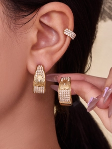 Macro shot of 18k gold plated C-shaped floral earrings with sparkling zircon inlay