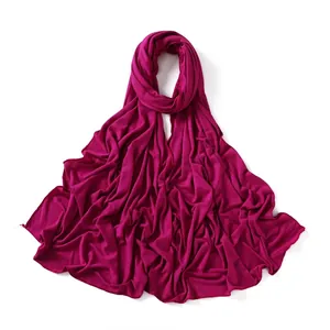 Detailed close-up of dark rose red jersey hijab with professional hemmed edges