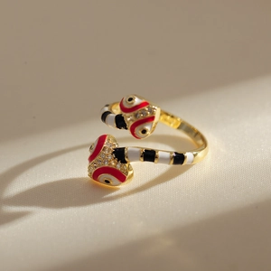 Macro shot of 18K gold plated double snake ring with colorful enamel and micro-inlaid gems