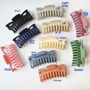 Flat lay of 10-piece matte bow-shaped shark hair clips in assorted vibrant colors