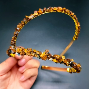 Detailed view of Tiger Eye crystal chips wrapped in gold wire on a bridal crown headband