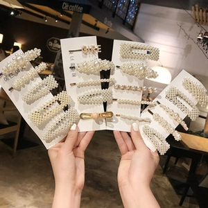 Detail of girl's pearl hair clip set with gold alloy base and GIRL letter design