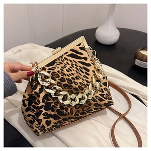Close-up of leopard print handbag featuring gold metal clasp and chunky chain detail