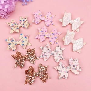 Set of 10 glitter sequins and floral bow hair clips for girls on pink background