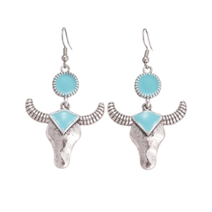 Bohemian bull head earrings in vintage silver with turquoise enamel on white background