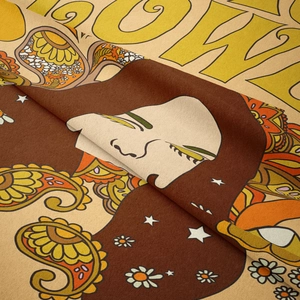Close-up of retro hippie tapestry featuring abstract figures and soft velvet texture