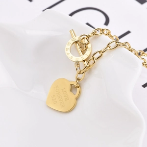 Gold hip hop heart pendant necklace with Roman numeral toggle clasp on white background