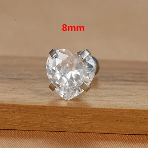 Macro shot of 8mm heart-cut clear zircon stud earring with four-claw titanium steel setting