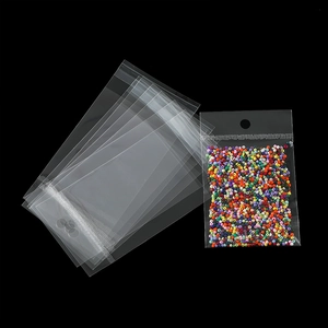 Detail view of holographic OPP self-sealing bag with hanging hole and colorful beads inside