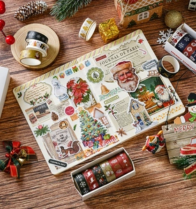Detailed view of Christmas washi tape and vintage stickers on a dark wooden background