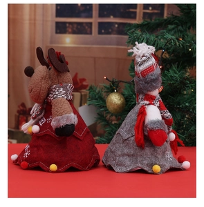 Close-up of reindeer and snowman Christmas gift bags with cozy knit and felt textures