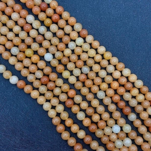 Macro shot of natural red aventurine round stone beads for DIY jewelry making