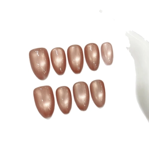 Cat eye press-on nails in sparkling rose gold almond shape with shimmery glass bead finish