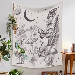 Detail of bohemian wall tapestry featuring butterfly and mushroom botanical line art