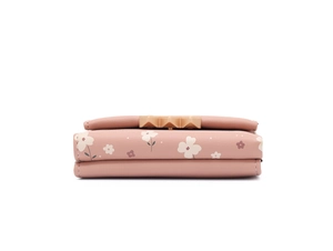 Side view of pink floral tri-fold wallet showing compact structure and metal clasp