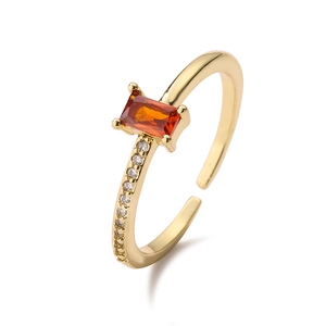 French style gold open ring with emerald-cut orange zircon and white accents on white background