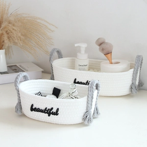 Close-up of white handwoven cotton rope baskets with beautiful embroidery for desk storage