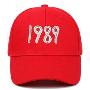 Detail of red cotton baseball cap featuring white 3D embroidered 1989 text on front