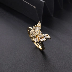 Macro shot of gold butterfly ring featuring zircon pavé and adjustable open band detail