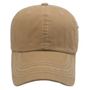 Detail of khaki cotton baseball cap showing contrast white zigzag stitching on the brim