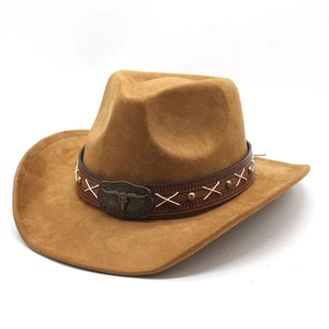 Detail of brown suede cowboy hat with bull head metal buckle and studded leather band