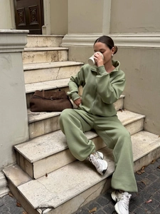 Women's light green two-piece tracksuit set with half-zip sweatshirt and jogger pants