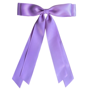 Detail of a large purple satin hair bow with long ribbons and smooth texture on white back
