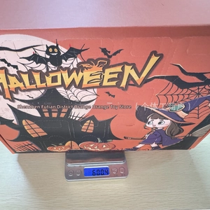 Detailed Halloween gift box featuring cartoon witch and pumpkin illustrations for toys