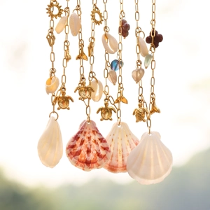 Golden ocean theme necklace with shell pendants, sea turtle and sun charms for women