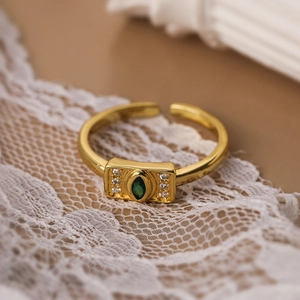 18K gold plated adjustable ring with green marquise gemstone on white lace fabric