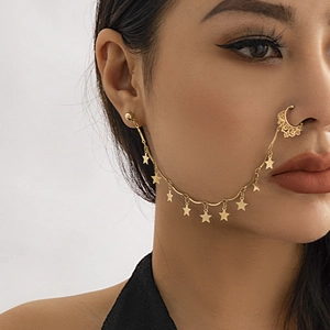 Detail view of punk style nose ring with star pendants and butterfly tassel chain