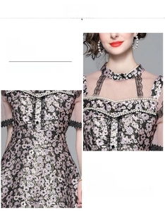 Detail of beaded halter neck and floral lace pattern on a slimming high waist dress