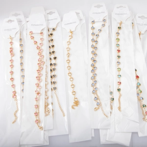 Detailed flat lay of heart-shaped stainless steel bracelets with colorful crystal stones