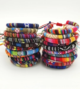 Flat lay of colorful bohemian woven bracelets with diverse geometric ethnic patterns