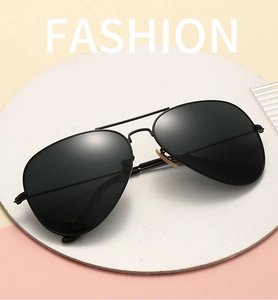 Detail view of aviator sunglasses with matte black metal frame and polarized lenses