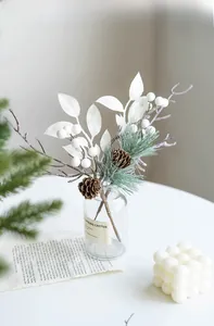 Detail of Christmas spray with white berries, pine needles and natural pine cones