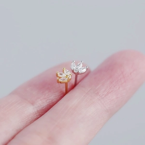 Close-up of S925 silver leaf crown earrings in gold and silver with cubic zirconia