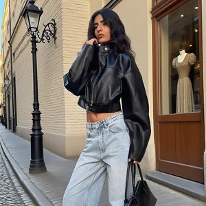 Outdoor street style featuring a cropped black leather jacket and wide-leg jeans